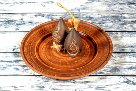 Handmade clay jugs  with grape pattern with ropes attached on clay plateの写真素材