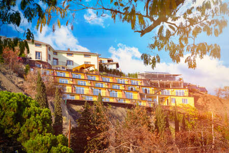 Colorful houses on the mountain . View through tree leaves.の写真素材