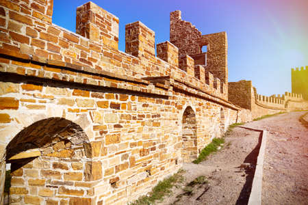 Fragment of  a old tower,  remains of the fortress against blue sky.の写真素材