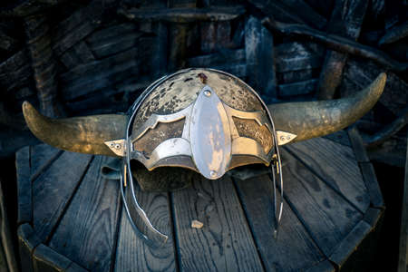 Old knight helmet on the wooden stand.の写真素材