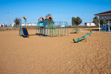 Playground stands on the sand in the beach.の写真素材