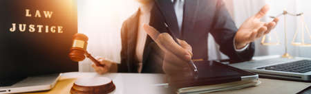 Justice and law concept.Male judge in a courtroom with the gavel, working with, computer and docking...