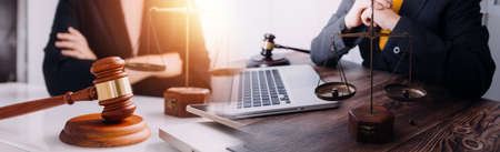 Justice and law concept.Male judge in a courtroom with the gavel, working with, computer and docking...