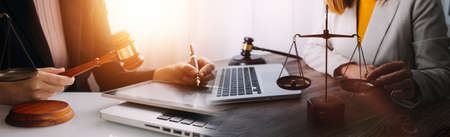 Justice and law concept.Male judge in a courtroom with the gavel, working with, computer and docking...