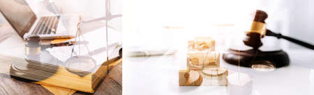 Justice and law concept.Male judge in a courtroom with the gavel, working with, computer and docking keyboard, eyeglasses, on table in morning lightの写真素材