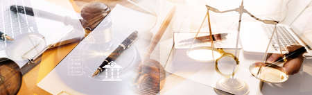 Justice and law concept.Male judge in a courtroom with the gavel, working with, computer and docking keyboard, eyeglasses, on table in morning lightの写真素材