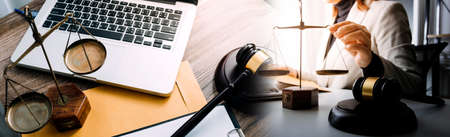 Justice and law concept.Male judge in a courtroom with the gavel, working with, computer and docking...