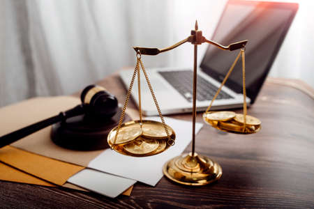 Business and lawyers discussing contract papers with brass scale on desk in office. Law, legal...