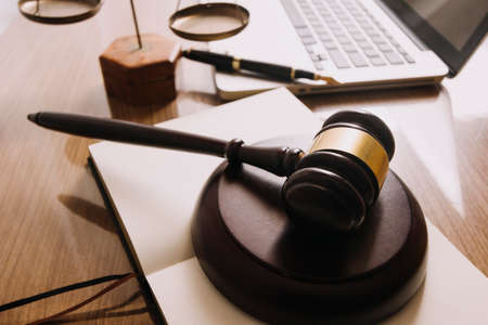 Business and lawyers discussing contract papers with brass scale on desk in office. Law, legal...