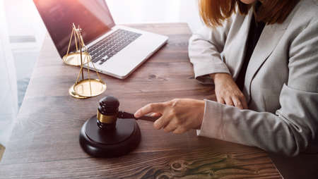 Justice and law concept.Male judge in a courtroom with the gavel, working with, computer and docking...