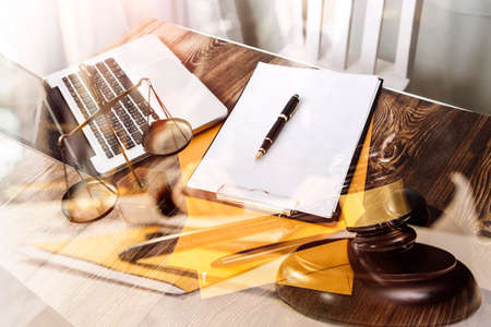 Business and lawyers discussing contract papers with brass scale on desk in office. Law, legal services, advice, justice and law concept picture with film grain effectの写真素材