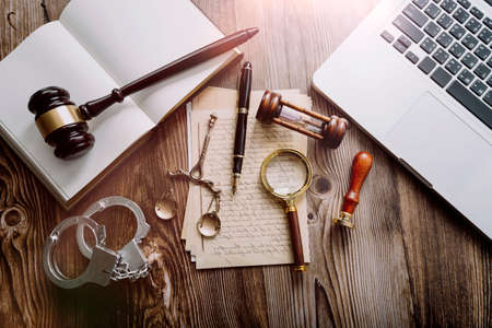 Business and lawyers discussing contract papers with brass scale on desk in office. Law, legal services, advice, justice and law concept picture with film grain effectの写真素材
