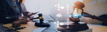 Justice and law concept.Male judge in a courtroom with the gavel, working with, computer and docking...