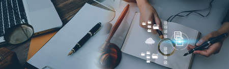 Justice and law concept.Male judge in a courtroom with the gavel, working with, computer and docking...