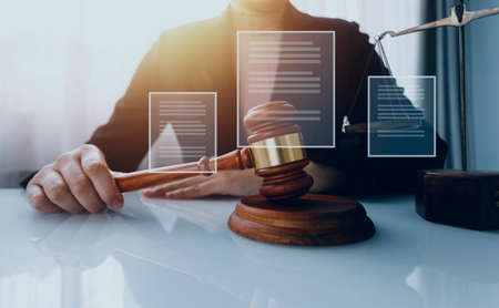 Business and lawyers discussing contract papers with brass scale on desk in office. Law, legal...