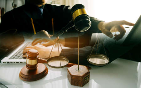 Business and lawyers discussing contract papers with brass scale on desk in office. Law, legal...