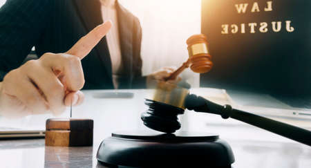 Business and lawyers discussing contract papers with brass scale on desk in office. Law, legal...