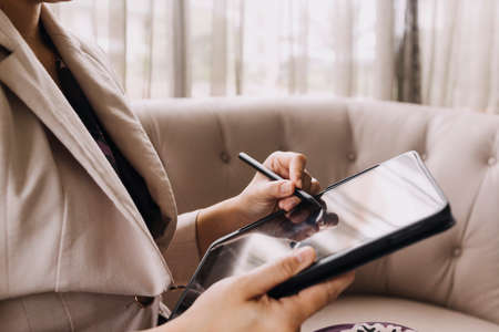 Businessman and team analyzing financial statement Finance task. with smart phone and laptop and...