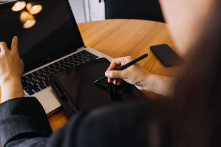 Businessman and team analyzing financial statement Finance task. with smart phone and laptop and...