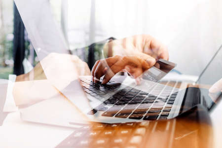 Businessman and team analyzing financial statement Finance task. with smart phone and laptop and...