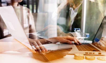 Businessman and team analyzing financial statement Finance task. with smart phone and laptop and...