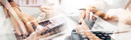 Businessman and team analyzing financial statement Finance task. with smart phone and laptop and...