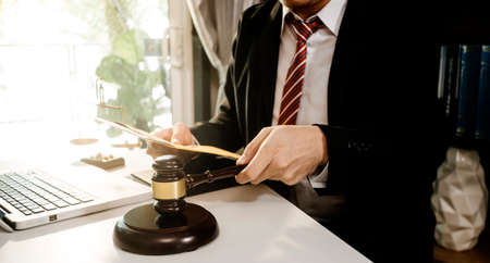 Justice and law concept.Male judge in a courtroom with the gavel, working with, computer and docking...