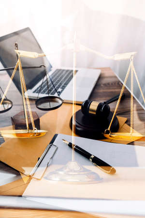 Business and lawyers discussing contract papers with brass scale on desk in office. Law, legal...