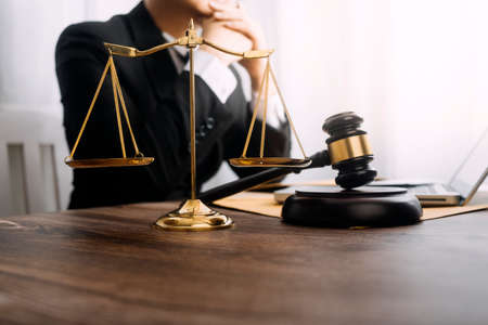 Business and lawyers discussing contract papers with brass scale on desk in office. Law, legal...