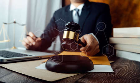 Business and lawyers discussing contract papers with brass scale on desk in office. Law, legal...