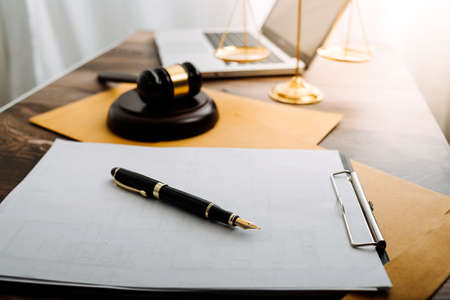 Business and lawyers discussing contract papers with brass scale on desk in office. Law, legal...