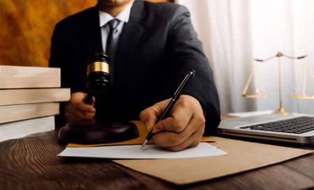 Business and lawyers discussing contract papers with brass scale on desk in office. Law, legal...