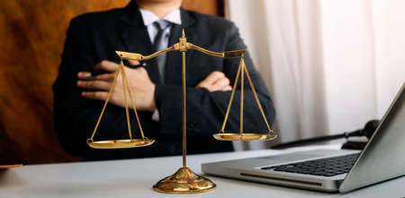 Justice and law concept.Male judge in a courtroom with the gavel, working with, computer and docking...