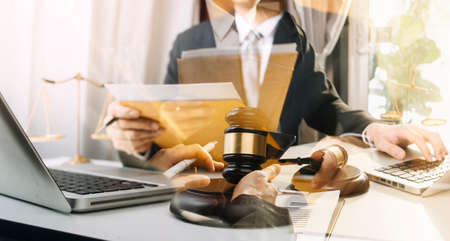 Business and lawyers discussing contract papers with brass scale on desk in office. Law, legal...