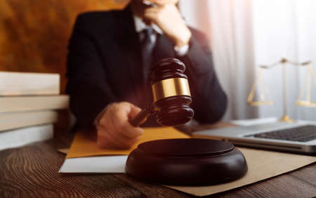 Business and lawyers discussing contract papers with brass scale on desk in office. Law, legal...