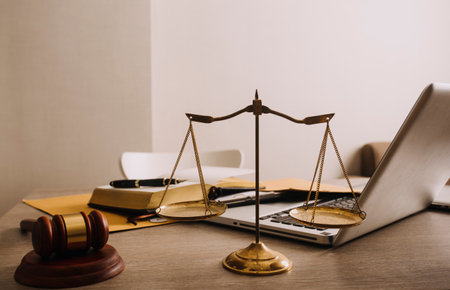 Male lawyer working with contract papers and wooden gavel on tabel in courtroom. justice and law...