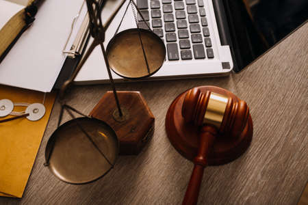 Male lawyer working with contract papers and wooden gavel on tabel in courtroom. justice and law...