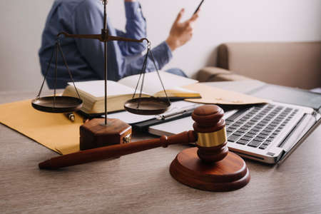 Male lawyer working with contract papers and wooden gavel on tabel in courtroom. justice and law...
