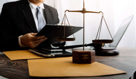 Justice and law concept.Male judge in a courtroom with the gavel, working with, computer and docking...
