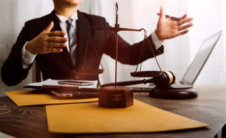 Business and lawyers discussing contract papers with brass scale on desk in office. Law, legal...
