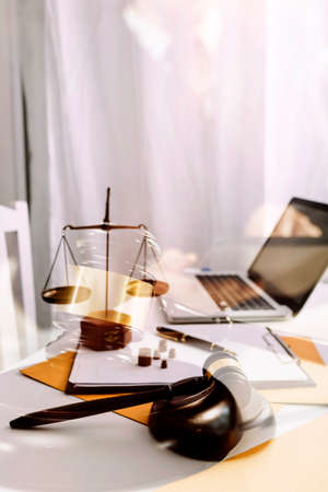 Business and lawyers discussing contract papers with brass scale on desk in office. Law, legal...