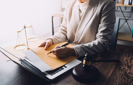 Business and lawyers discussing contract papers with brass scale on desk in office. Law, legal...
