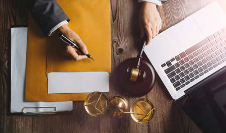 justice and law concept.Male judge in a courtroom on wooden table and Counselor or Male lawyer...