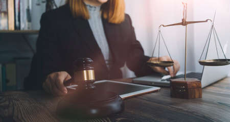Justice and law concept.Male judge in a courtroom with the gavel, working with, computer and docking...