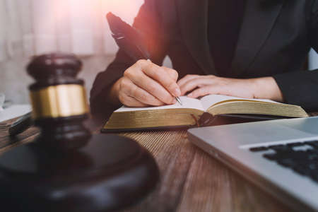 Justice and law concept.Male judge in a courtroom with the gavel, working with, computer and docking...