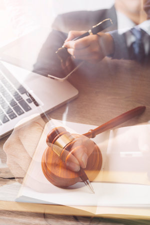 Male lawyer working with contract papers and wooden gavel on tabel in courtroom. justice and law...