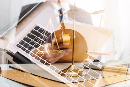 Male lawyer working with contract papers and wooden gavel on tabel in courtroom. justice and law...