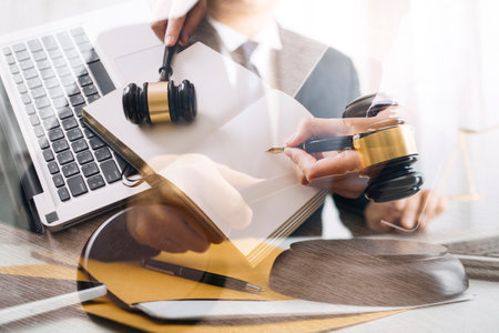 Male lawyer working with contract papers and wooden gavel on tabel in courtroom. justice and law...