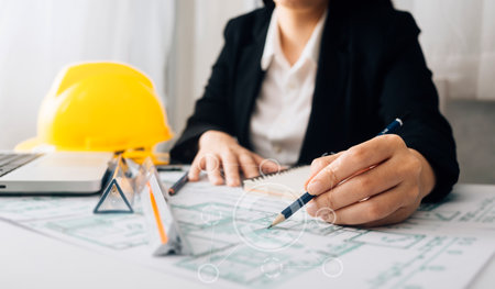 Two colleagues discussing data working and tablet, laptop with on on architectural project at...