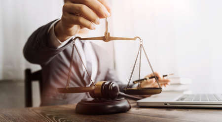 Business and lawyers discussing contract papers with brass scale on desk in office. Law, legal...